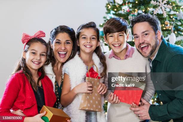 family with three children at christmas - christmas tree close up stock pictures, royalty-free photos & images