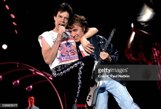 British musicians Mick Jagger and Bill Wyman of the Rolling Stones performs on stage during the band's 'Steel Wheels' tour, late 1989.