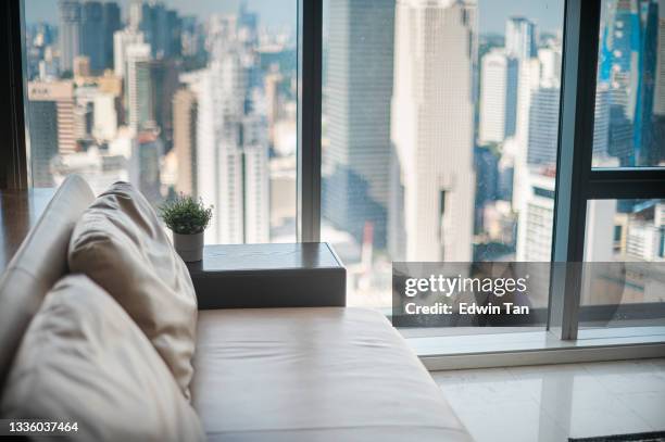 kuala lumpur skyscraper through window of high rise condominium in day time - grand room stock pictures, royalty-free photos & images