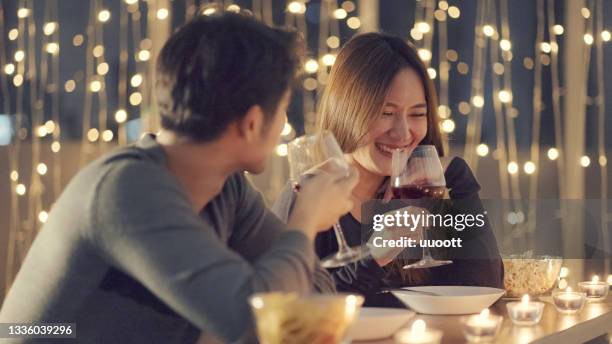 couple enjoying the wine at dinner - asian couple dinner stock pictures, royalty-free photos & images