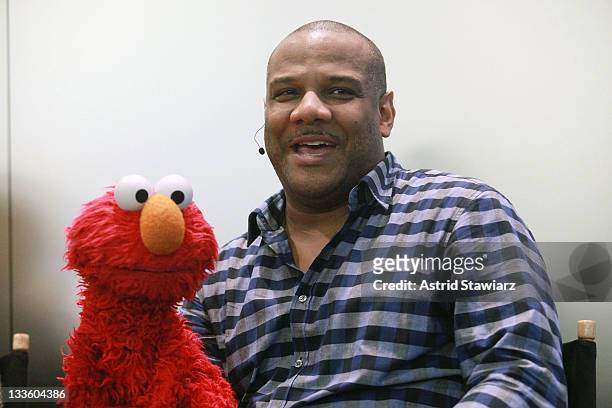Puppeteer Kevin Clash and Elmo talk at the Apple Store Upper West Side on November 20, 2011 in New York City.