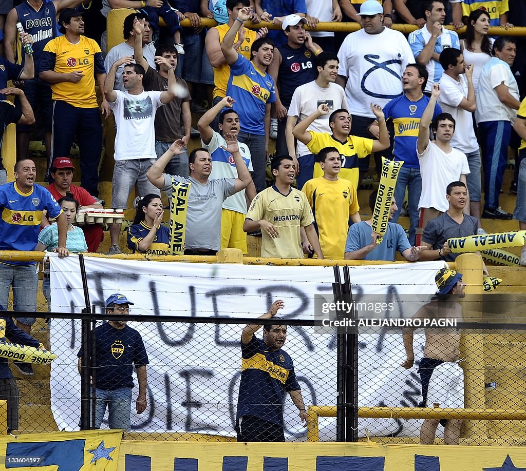 Fans of Boca Juniors cheer their team in