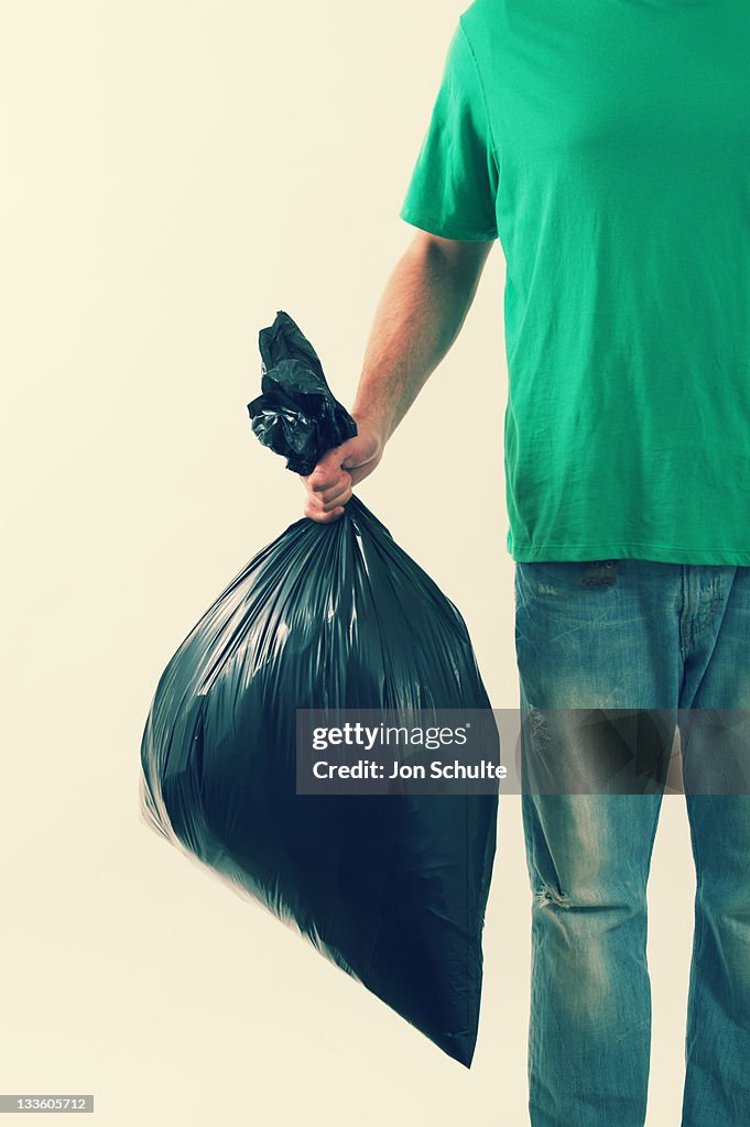 Man Holding Trash Bag
