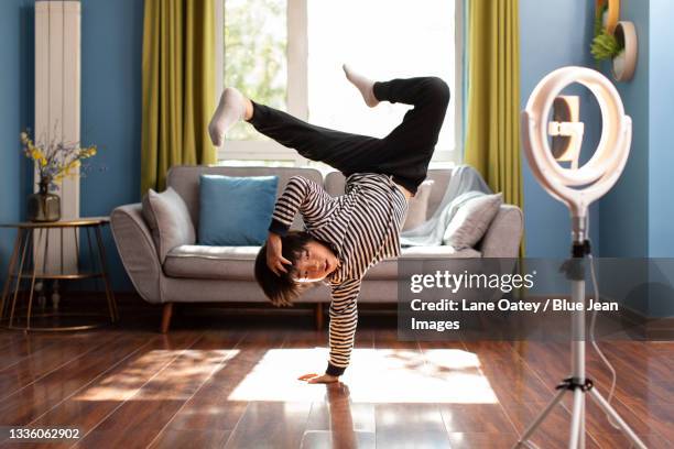 little chinese boy doing live webcast at home - asian male dancer stock pictures, royalty-free photos & images