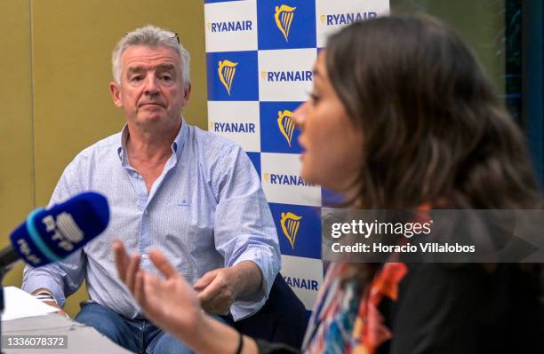Ryanair Group CEO Michael O'Leary listens to PR Manager Spain and Portugal Susana Limpo delivering remarks during a press conference in Lux Lisboa...