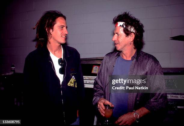 Backstage at the Rolling Stones' 'Voodoo Lounge' tour, British musician Keith Richards of the Rolling Stones talks with Izzy Stradlin, late 1994.