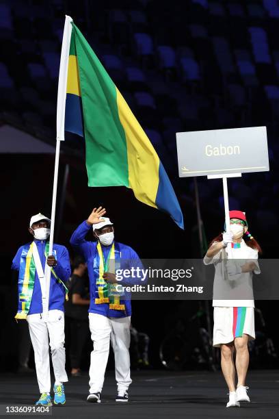 Flag bearer Davy Rendhel Moukagni Moukagni of team Gabon leads his delegation in the parade of athletes during the opening ceremony of the Tokyo 2020...