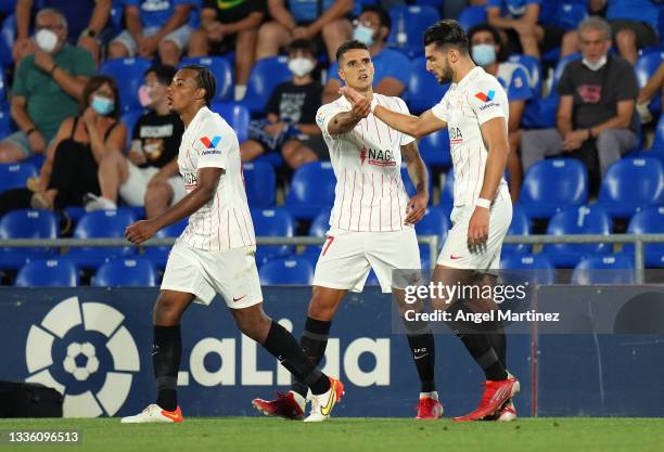 Erik Lamela of Sevilla celebrates with Rafa Mir after scoring their team's first goal during the La Liga Santander match between Getafe CF and...