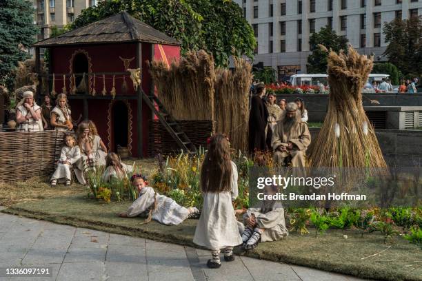 Actors dressed in traditional Ukrainian clothes prepare for a performance as part of an Independence Day parade on August 24, 2021 in Kyiv, Ukraine....