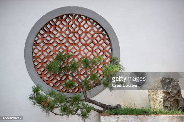 brick window on white wall of ancient chinese building - chinese wall stockfoto's en -beelden