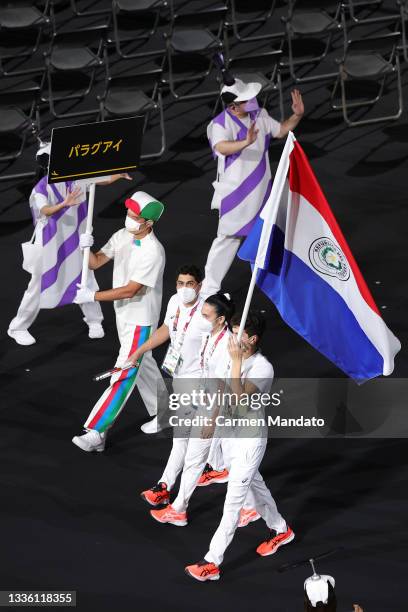 Flag bearers Melissa Nair Tillner Galeano and Rodrigo Hermosa of Team Paraguay lead their delegation in the parade of athletes during the opening...