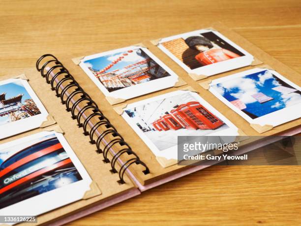 collection of instant travel holiday photos in a photo album - souvenirs stock-fotos und bilder
