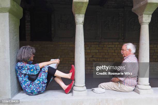 senior couple relaxing between two columns - cloister stock pictures, royalty-free photos & images