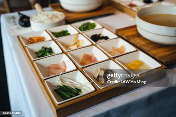 a bowl of hot soup and a box of side dishes on the table - square plate stock pictures, royalty-free photos & images