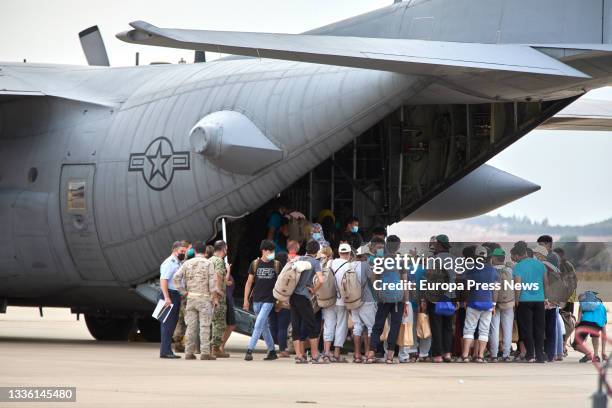 Group of Afghan youths and families, on their way to board a US plane to be transferred to Germany, at the Torrejon de Ardoz air base, on 24 August,...