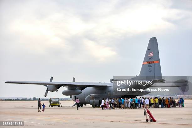 Group of Afghan youths and families, on their way to board a US plane to be transferred to Germany, at the Torrejon de Ardoz air base, on 24 August,...