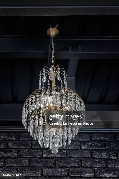 glass chandelier against black background. - chandelier stock pictures, royalty-free photos & images