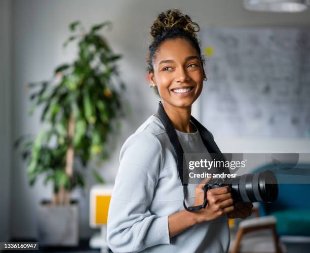 happy african american photographer holding a camera and smiling - black photographer stock pictures, royalty-free photos & images