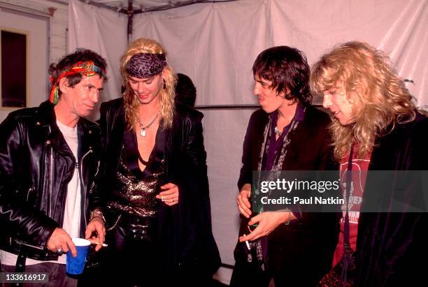 Backstage at the Rolling Stones' 'Steel Wheels' tour, British musician Keith Richards of the Rolling Stones talks with American musicians, from...