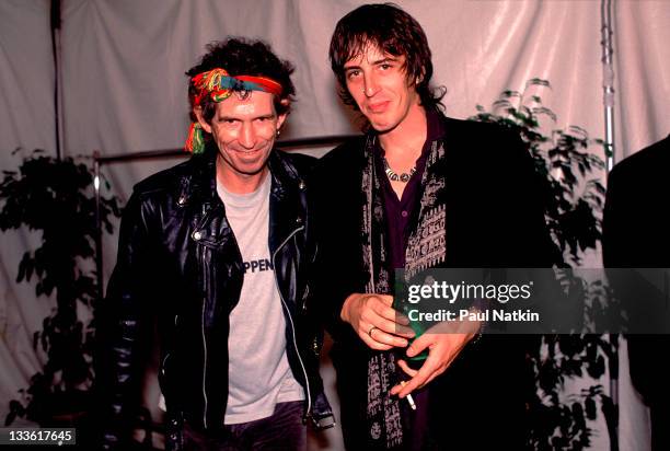 Backstage at the Rolling Stones' 'Steel Wheels' tour, British musician Keith Richards of the Rolling Stones poses with American musician Izzy...