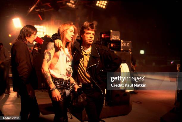 British musician Mick Jagger of the Rolling Stones poses on stage with American musician Axl Rose during the band's 'Steel Wheels' tour, late 1989....