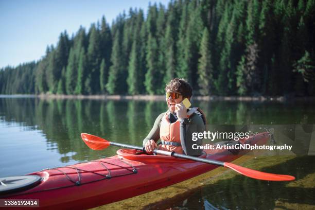 using technology during adventure. - rowboat bildbanksfoton och bilder