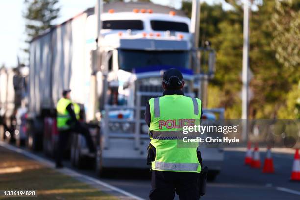 Queensland Police stop trucks at the Queensland border on August 25, 2021 in Coolangatta, Australia. The Queensland government has tightened border...