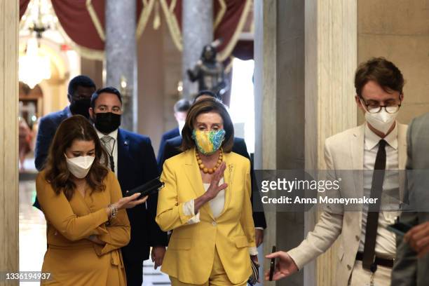 House Speaker Nancy Pelosi speaks to a reporter as she walks her office at the U.S. Capitol on August 24, 2021 in Washington, DC. After a group of...