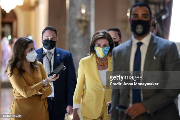 House Speaker Nancy Pelosi speaks to a reporter as she walks her office at the U.S. Capitol on August 24, 2021 in Washington, DC. After a group of...