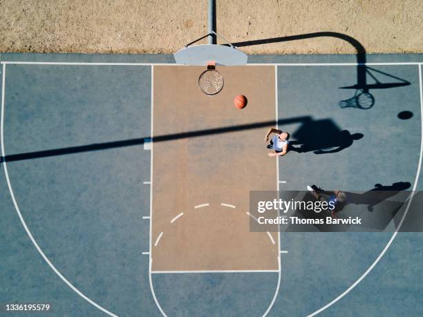 wide shot overhead view of senior men playing basketball on summer morning - old basketball hoop stock pictures, royalty-free photos & images