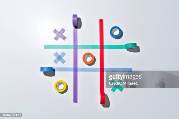 tic tac toe game with colorful adhesive tapes - tic tac toe stock-fotos und bilder