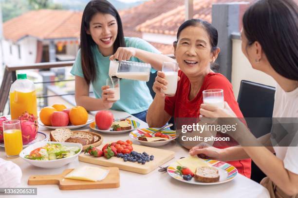 happy family having breakfast together at home - drink milk stock pictures, royalty-free photos & images