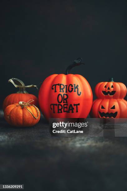 halloween background with jack o' lantern and orange pumpkins with trick or treat message - hello october stock pictures, royalty-free photos & images