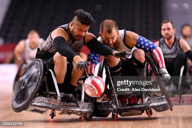 Tainafi Lefono of Team New Zealand is tackled by Charles Melton of Team United States during the Wheelchair Rugby Pool Phase Group B match between...