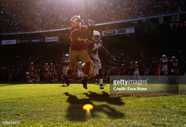 Vernon Davis of the San Francisco 49ers catches a touchdown pass in front of Rashad Johnson of the Arizona Cardinals at Candlestick Park on November...