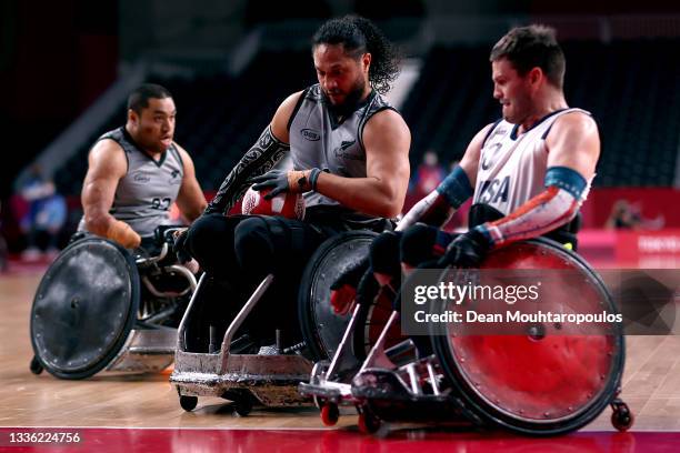 Hayden Barton-Cootes of New Zealand battles for the ball with Joshua Wheeler of United States of America during the Group B Wheelchair Rugby match...