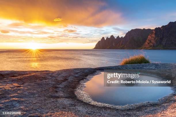 sunset over the fjord, tungeneset, senja, norway - sole di mezzanotte foto e immagini stock