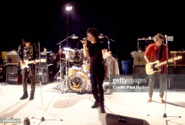 From left, British musicians Ron Wood, Mick Jagger, and Keith Richards of the Rolling Stones perform during the band's 'Voodoo Lounge' tour, late...