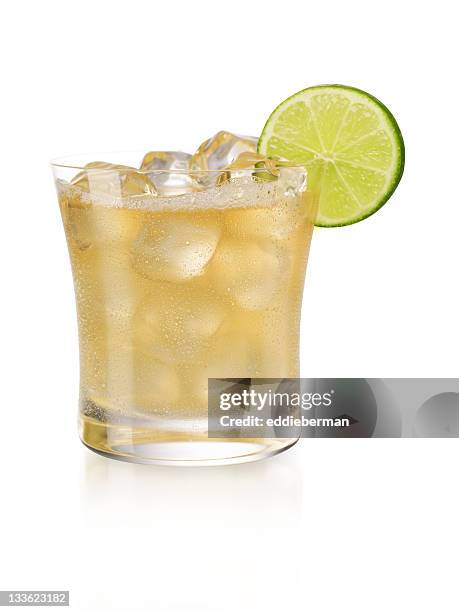 display of a margarita on the rocks with a slice of lime  - margarita stock pictures, royalty-free photos & images