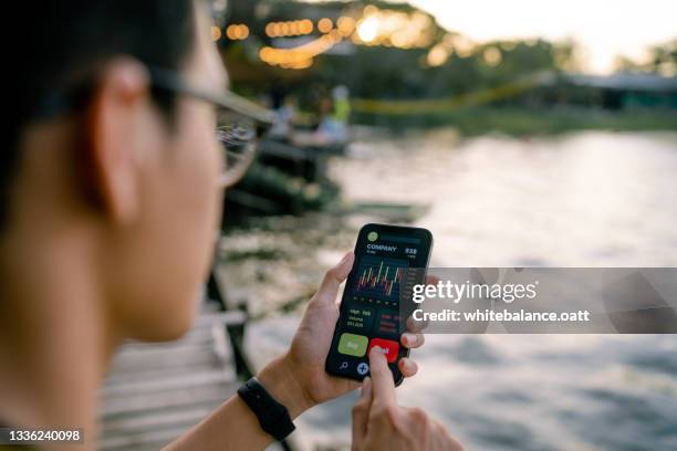 young experts analyze financial charts on smartphones. - visual aid stock pictures, royalty-free photos & images