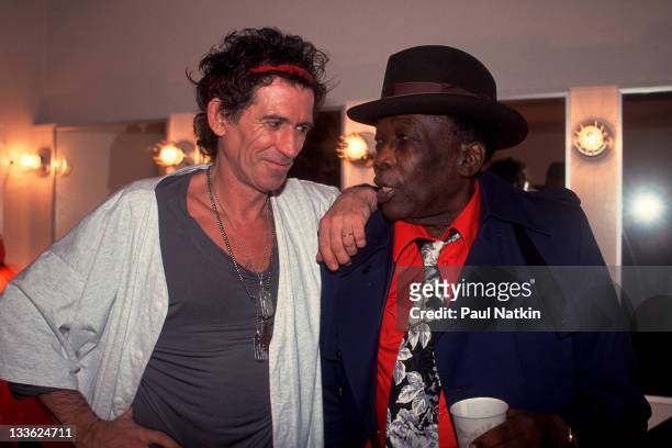 British musician Keith Richards backstage American musician John Lee Hooker on the former's 'Main Offender' tour, early 1993.