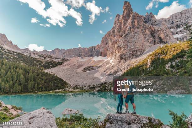 young couple in love kissing each other. wonderful panorama of the swiss alps in the background - venezia stock pictures, royalty-free photos & images