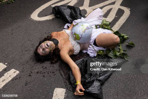 Extinction Rebellion protesters gather outside the Brazilian Embassy to protest for indigenous rights in the Amazon, on August 25, 2021 in London,...