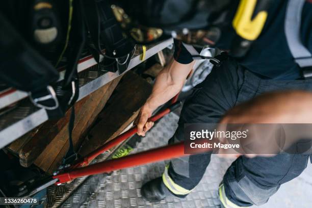 close up view of a firefighter using a big cutter pliers - red car wire stock pictures, royalty-free photos & images