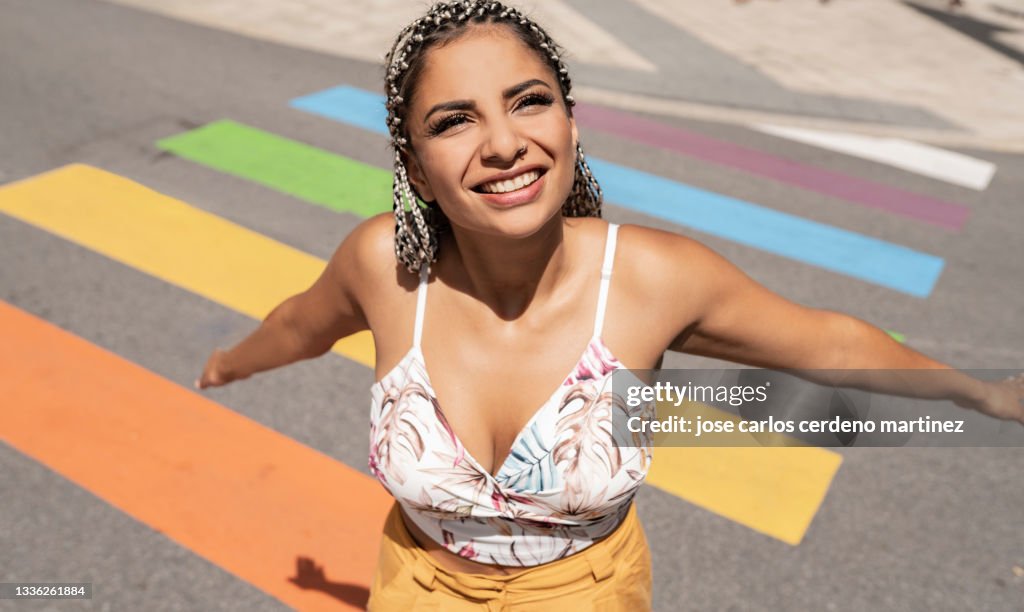 Woman on rainbow zebra crossing lgbt