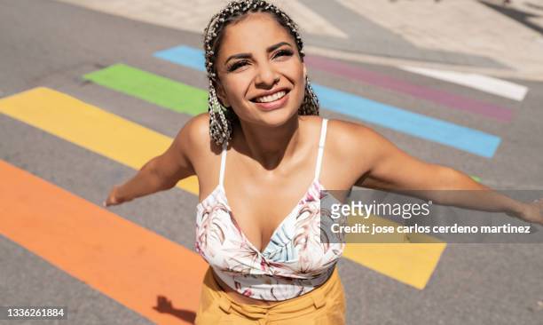 woman on rainbow zebra crossing lgbt - madrid stock pictures, royalty-free photos & images