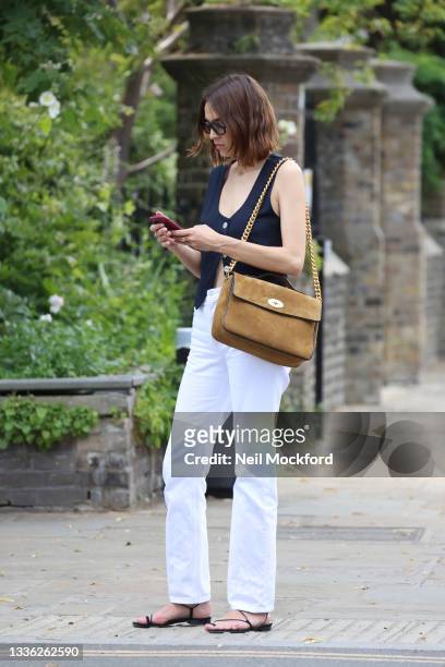 Alexa Chung wears the 'Big Guy' in Tan & Black Suede & Patent from the Mulberry x Alexa Chung collection whilst out and about in London on July 20,...