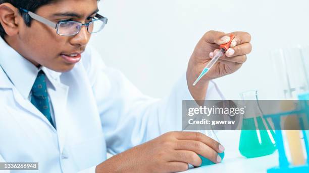 science student does chemistry practical in a laboratory. - india lab stockfoto's en -beelden