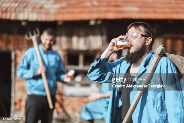 tired farm worker cooling off with beer after a hard day's work - beer goggles stock pictures, royalty-free photos & images