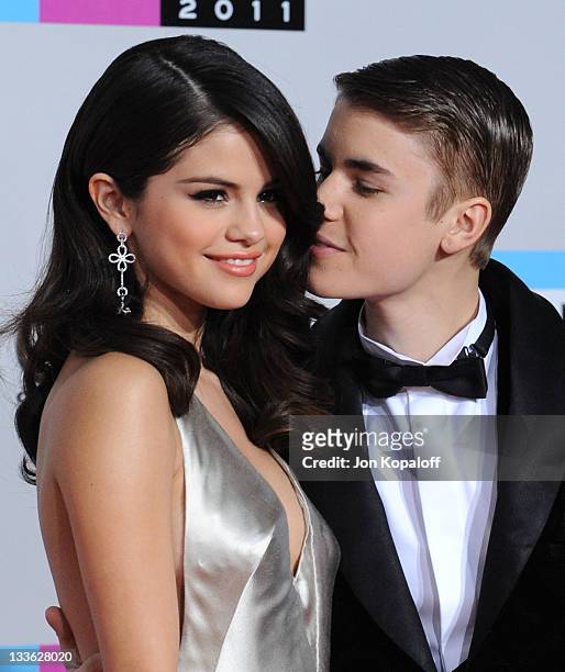 Singers Selena Gomez and Justin Bieber arrive at the 2011 American Music Awards held at Nokia Theatre L.A. Live on November 20, 2011 in Los Angeles,...